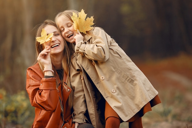 Cute and stylish family in a autumn park