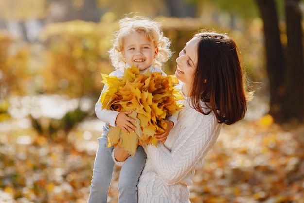 Cute and stylish family in a autumn park