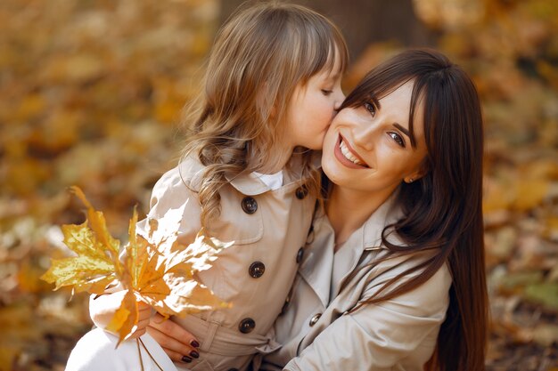 Cute and stylish family in a autumn park