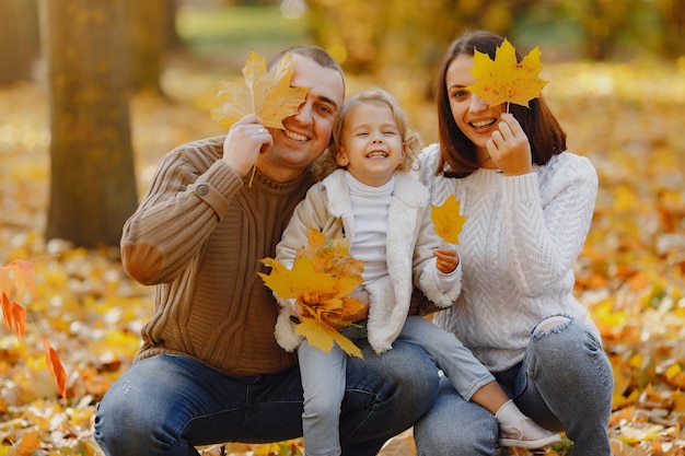 Cute and stylish family playing in a autumn field