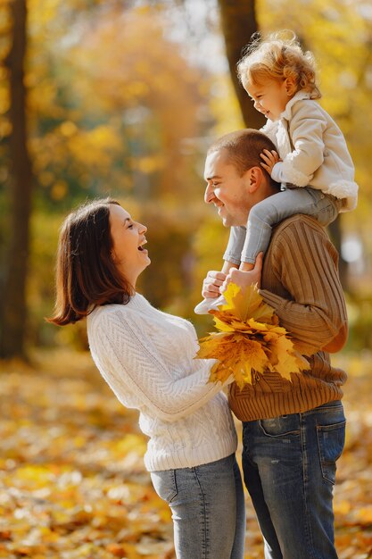 Cute and stylish family playing in a autumn field