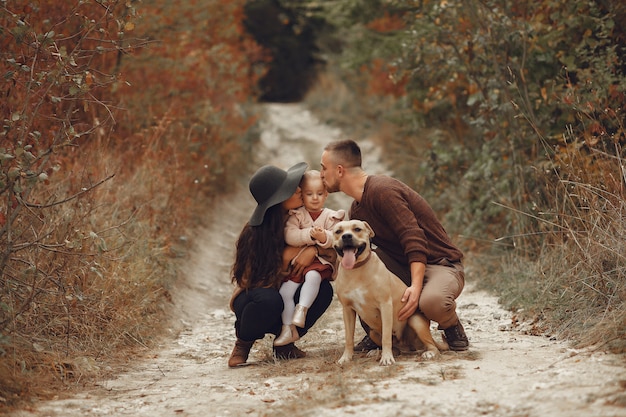 Cute and stylish family playing in a field