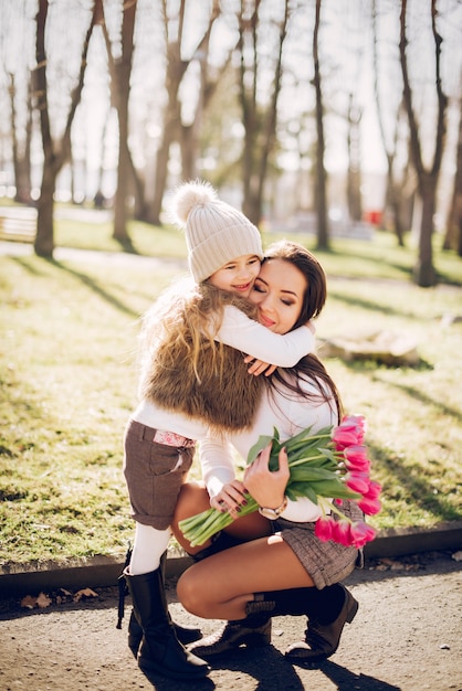 Free photo cute and stylish family in a spring park