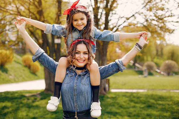 Free photo cute and stylish family in a spring park