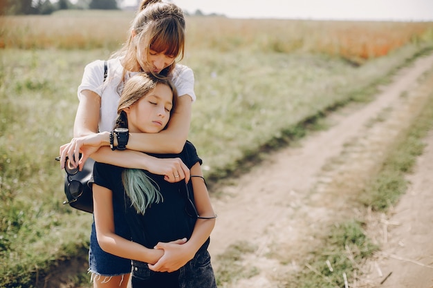 Free photo cute and stylish family in a summer field