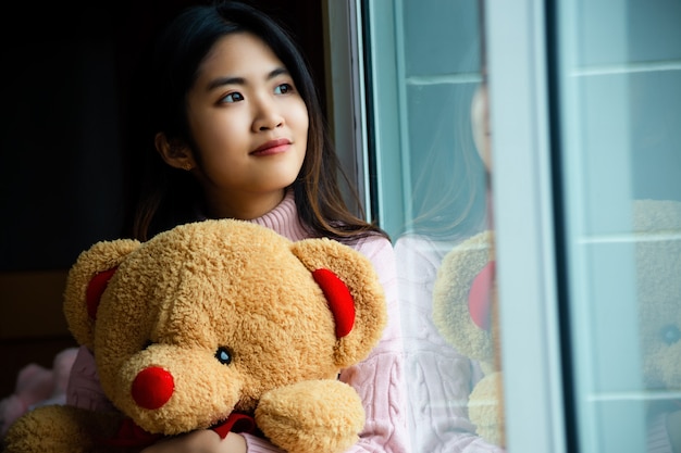 Cute teenage with large teddy bear