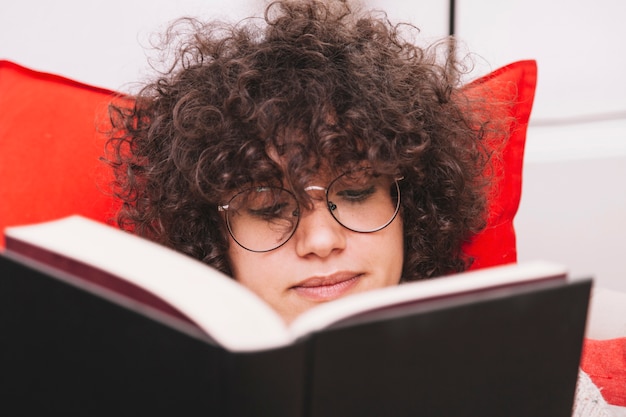 Cute teenager reading book