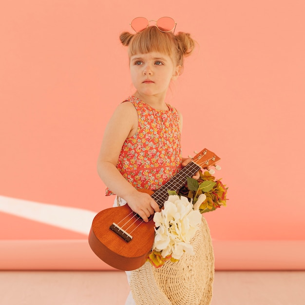 Free Photo cute toddler posing with guitar