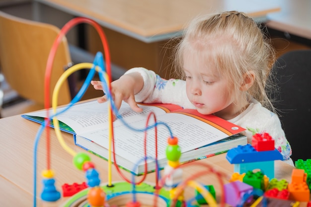 Cute toddler reading book