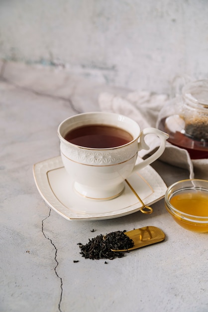 Cute white cup of tea on marble background