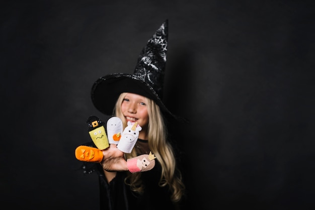 Free Photo cute witch with halloween toys