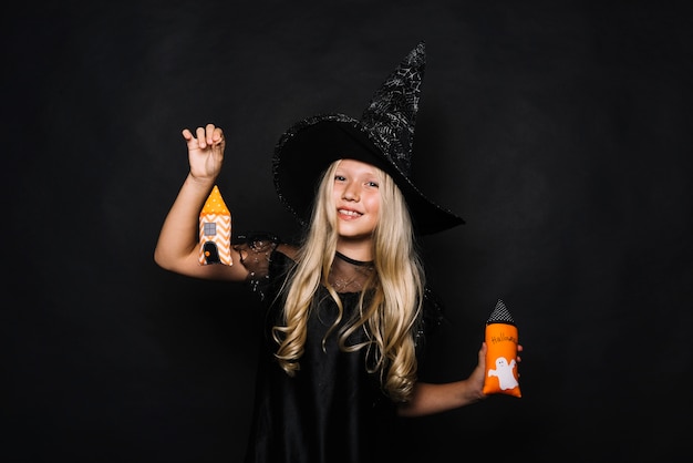 Free Photo cute witch with toy towers