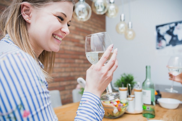 Cute woman drinking wine at home