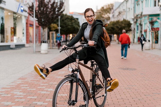 Cute woman fooling around on her bike