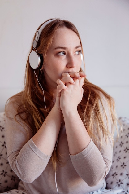 Cute woman in headphones looking away