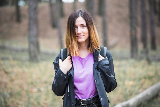 Cute woman travelling through forest