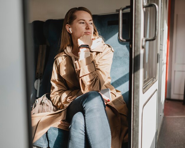 Cute woman waiting for the train to leave the railway station