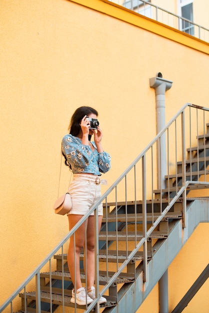 Free Photo cute woman with black hair taking a photo