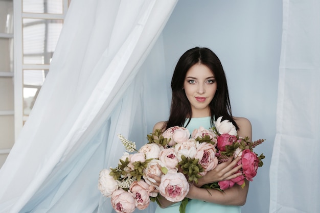 Cute woman with floral bouquet