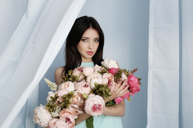 Cute woman with floral bouquet