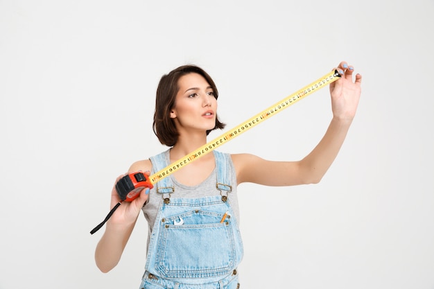 Cute woman with tape measure renovate house