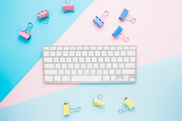 Free photo cute workplace with keypad and clips