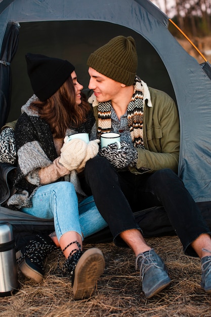 Cute young couple with hot drinks