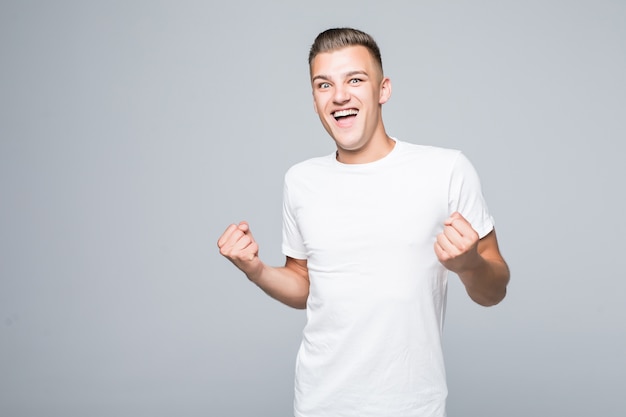 Free photo cute young man boy shows happy victory sign isolated on white wall