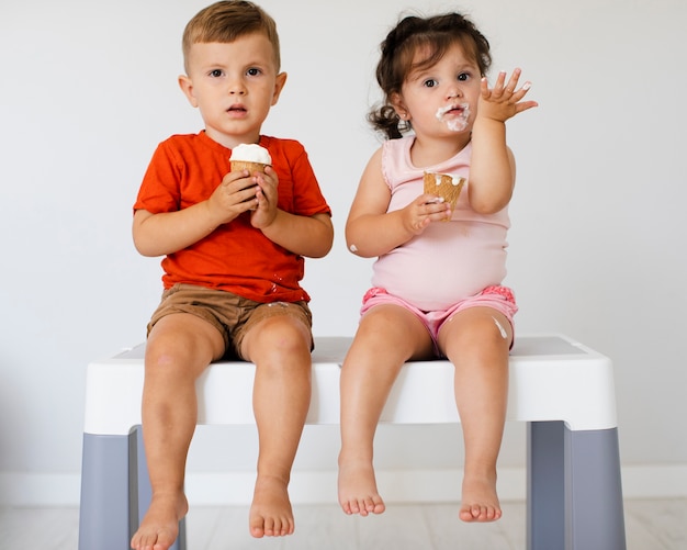 Cute young siblings looking at camera