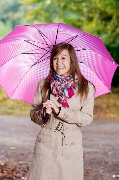 Free photo cute young woman with umbrella