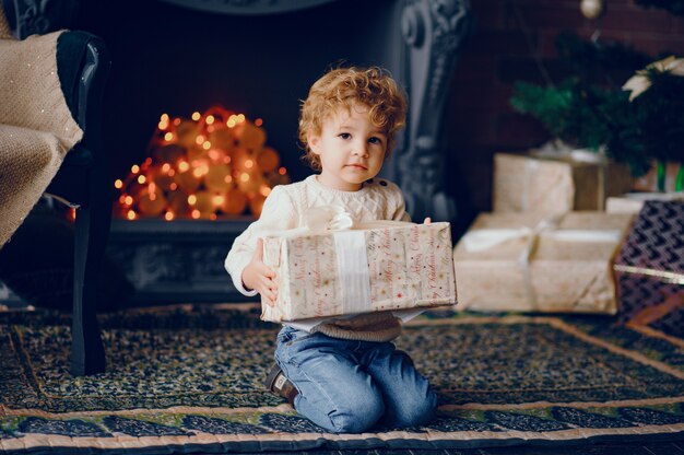 Cutte little boy at home near christmas decorations