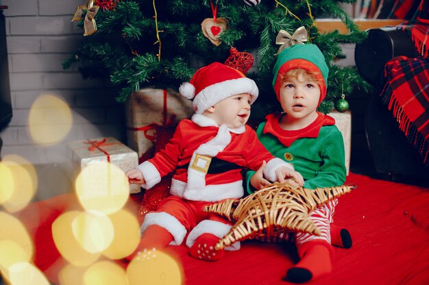 Cutte little brothers at home near christmas decorations