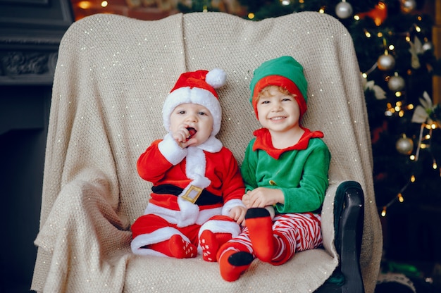 Cutte little brothers at home near christmas decorations