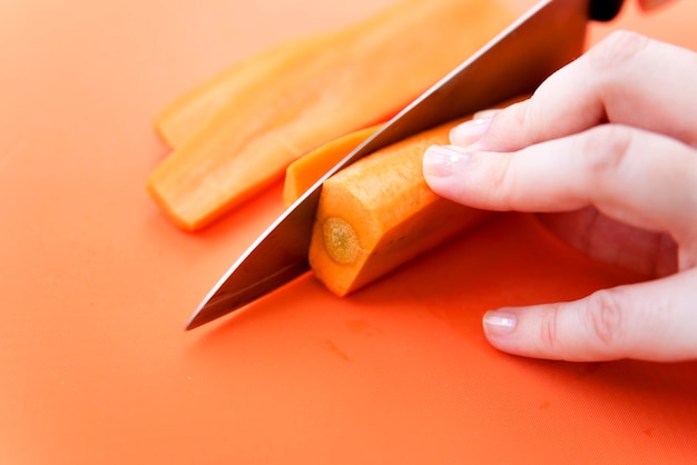 Free photo cutting carrots