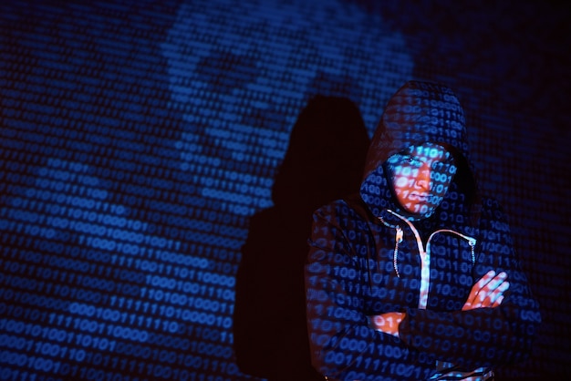 Free photo cyber attack with unrecognizable hooded hacker using virtual reality, digital glitch effect