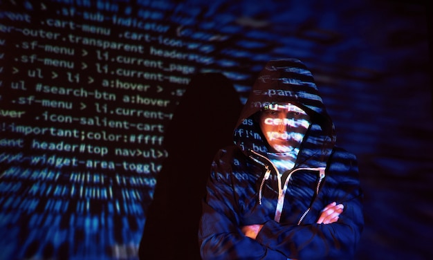 Free photo cyber attack with unrecognizable hooded hacker using virtual reality, digital glitch effect