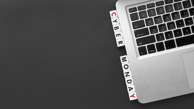 Cyber monday written with scrabble letters and laptop copy space