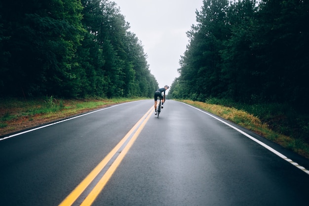 Cyclist man riding a bike on the road