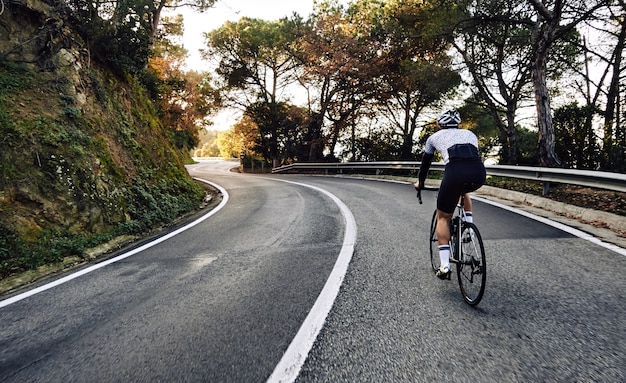 Cyclist man riding a bike on the road