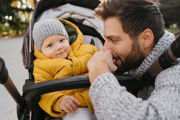 Dad and child in stroller outside in nature