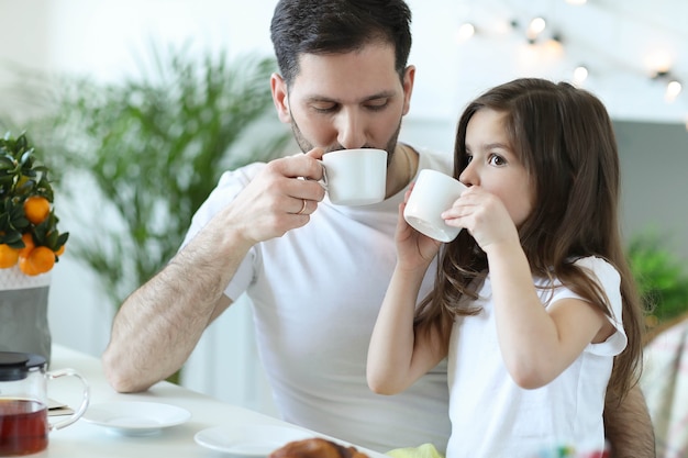 Dad and daughter having breakfast in the kitchen