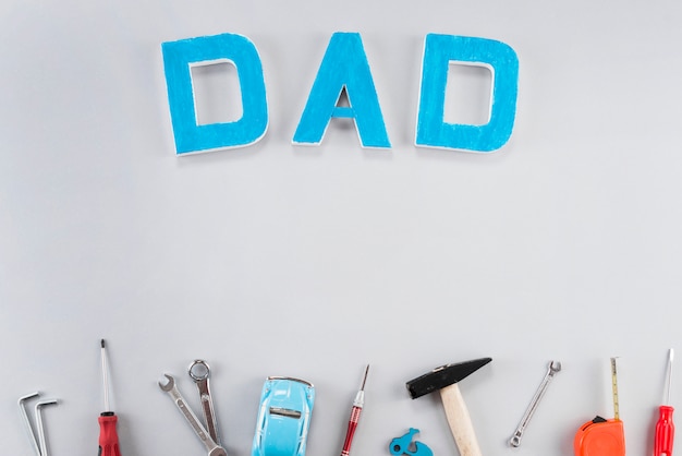 Dad inscription with tools on table