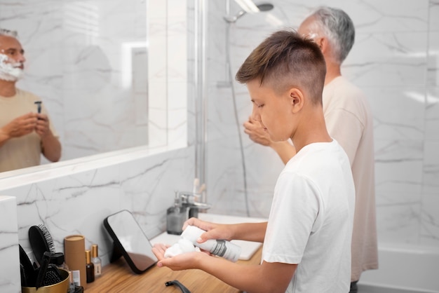 Dad teaching his boy how to shave