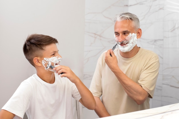 Dad teaching his boy how to shave