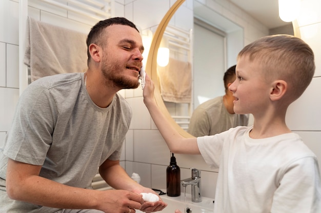 Dad teaching his son how to shave