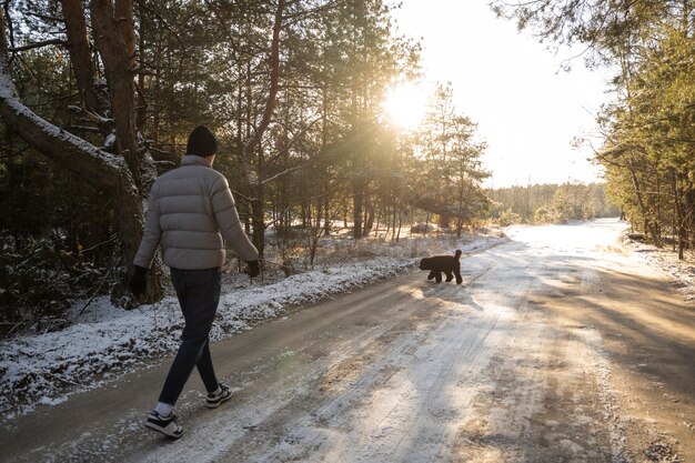 Free photo dad walking in nature with his dog