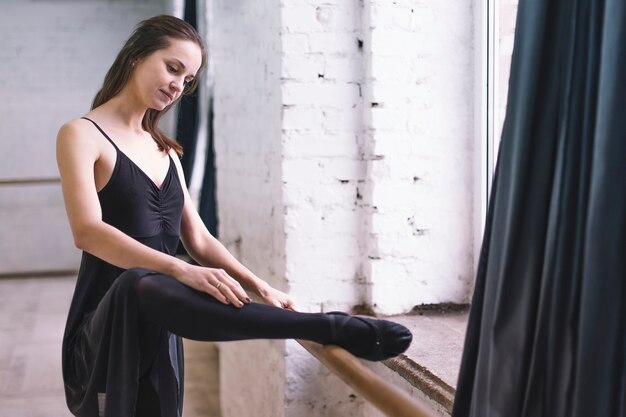 Dancer exercising near barre