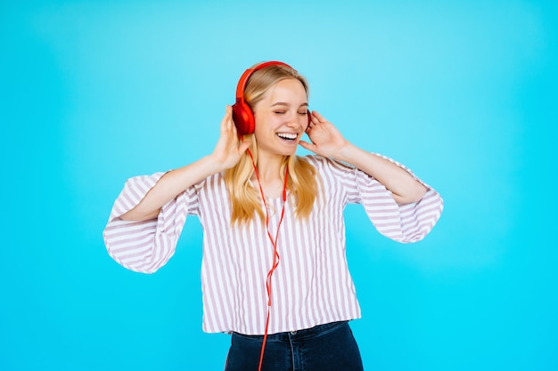 Dancing woman listens to music in headphones