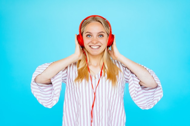 Dancing woman listens to music in headphones