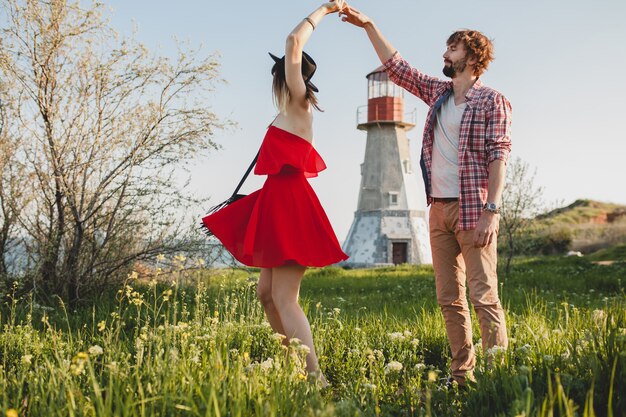 Dancing young stylish couple in love in countryside